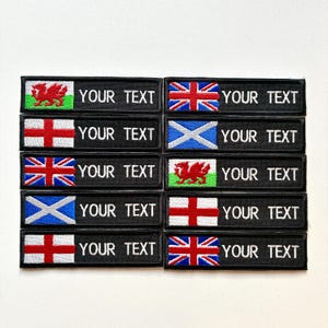 May include: A selection of black embroidered patches displaying flags such as the Union Jack, the Welsh dragon, and the St. George's Cross. Each patch includes the text "YOUR TEXT" in white, allowing for personalization.