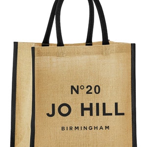 May include: A brown jute tote bag with black handles and trim. The bag has the text "No. 20 JO HILL BIRMINGHAM" printed on the front.