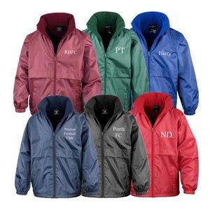 May include: Seven zipped hooded jackets in a range of colours: red, blue, green, and black. Each jacket has a contrasting collar and embroidered text, including "RBFC" and "Harry". Ideal for sports teams or casual wear.