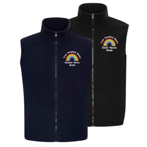 May include: Two fleece vests, one navy blue and one black, with a full zip and a high collar. Each vest has a rainbow graphic and text that reads "Your Hospital Name" and the wearer's title and name. The navy vest says "Student Nurse Sarah". The black vest says "Staff Nurse Phoebe".