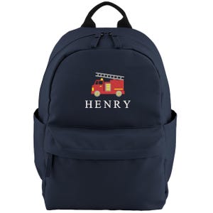 May include: Navy blue backpack with a red and yellow fire truck graphic and the name "HENRY" in white. The backpack has a top handle, two side pockets, and a front pocket. The fire truck has a ladder on top.