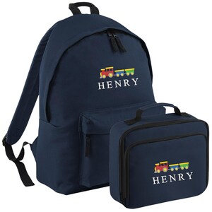 May include: Navy blue backpack and lunch bag set. Both items display a colourful train graphic and the name "HENRY" in white. The backpack has adjustable straps and a front pocket. The lunch bag has a handle.