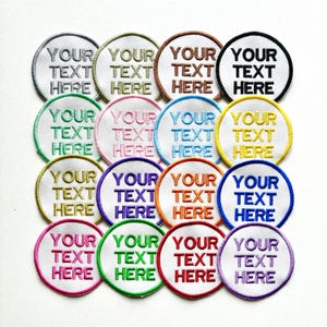May include: A selection of embroidered circular patches, each with the text "YOUR TEXT HERE". The patches feature a range of coloured borders and white centres, ideal for customisation and personalisation.