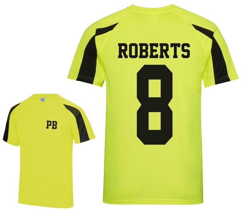 May include: A neon yellow athletic shirt with black accents on the shoulders and sleeves. The back of the shirt displays the name "ROBERTS" above the number "8" in black. The front of the shirt has the initials "PB" in black.