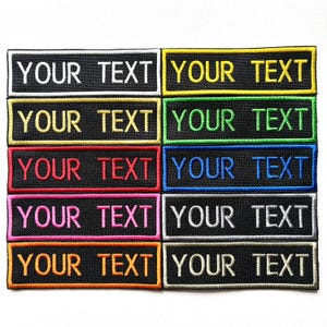 May include: A selection of black embroidered patches, each with the words "YOUR TEXT" in different colours. The patches have borders in contrasting colours, including white, yellow, green, red, blue, pink, orange, and grey.