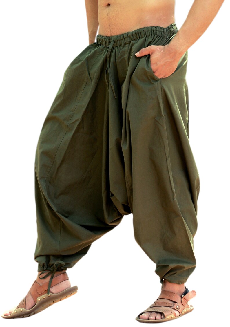 May include: Olive green loose-fitting pants with a drawstring waist and elastic cuffs. The pants are made of a soft, comfortable fabric and have a relaxed fit.
