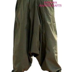 May include: A pair of olive green cotton harem pants with a drawstring at the ankles. The pants have a loose, baggy fit and are made of a soft, comfortable fabric.