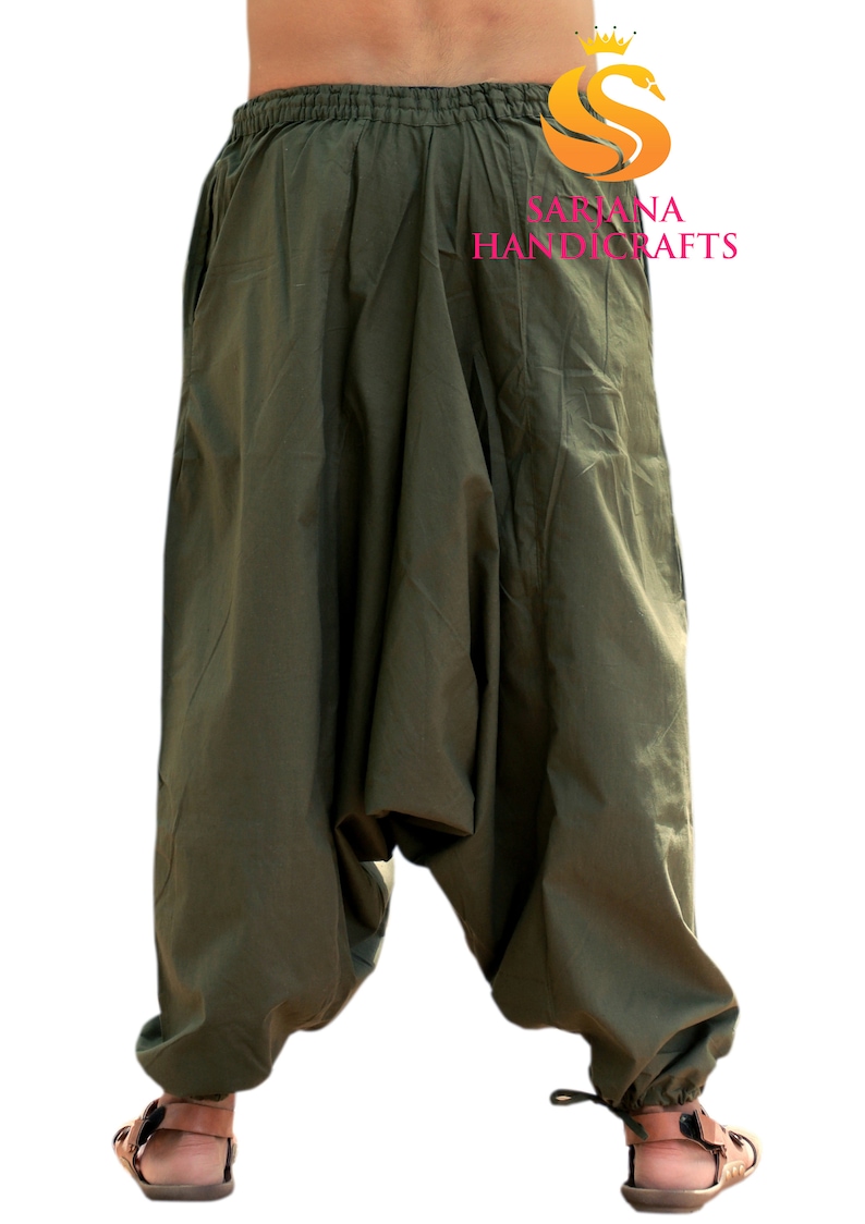 May include: A pair of olive green cotton harem pants with a drawstring at the ankles. The pants have a loose, baggy fit and are made of a soft, comfortable fabric.