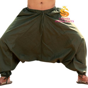 May include: A pair of olive green loose-fitting pants with a drawstring waist. The pants are gathered at the ankles and have a wide, flowing silhouette.