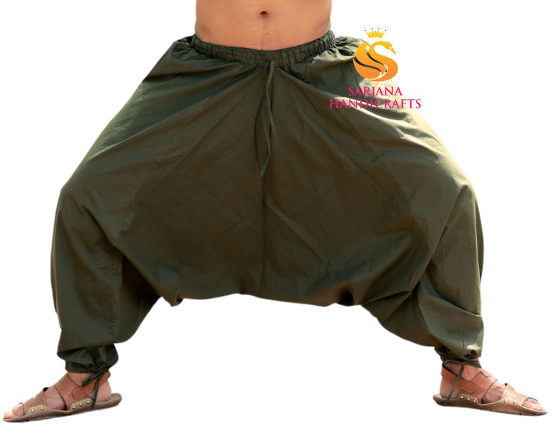 May include: A pair of olive green loose-fitting pants with a drawstring waist. The pants are gathered at the ankles and have a wide, flowing silhouette.