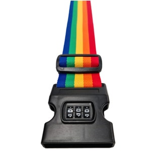 The image features a rainbow-colored strap with a black plastic lock buckle, typically used for securing items like luggage. The vibrant strap displays the full spectrum of rainbow colours in vertical stripes, and the traditional rainbow sequence.