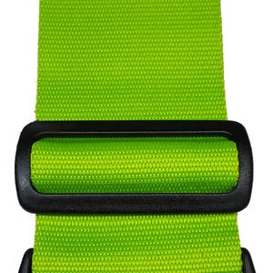 The image features a green -coloured strap with a black plastic buckle, typically used for securing items like luggage.