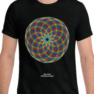 May include: A black t-shirt featuring a colourful geometric design on the front. The design is a circle with a rainbow of colours and a black centre. The text "001 of 100" and "AwakenUp Designs" is printed below the design.
