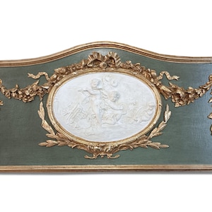 May include: A green and gold framed wall decor with a white oval relief sculpture of three cherubs. The frame is ornate with gold leaf and floral motifs.