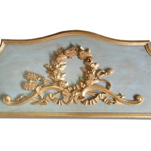 A carved wood architectural salvage or Carved Wood Panel GILT  is a decoration that arises at the top of a door.