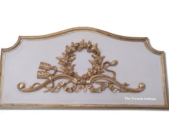 A carved wood architectural salvage or Carved Wood Panel GILT  is a decoration that arises at the top of a door.