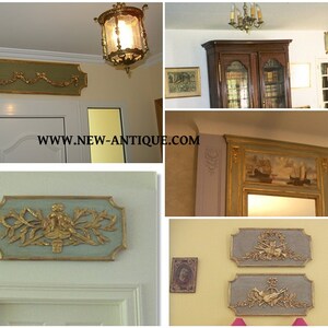 May include: A selection of antique wall decorations. The decorations feature ornate gold-coloured relief designs on rectangular panels. The panels have a light blue or green background and are framed with gold trim. Some panels feature floral or cherub motifs.
