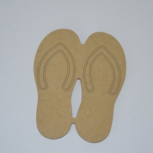 May include: A pair of brown wooden flip-flop cutouts. The flip-flops are connected at the toe.