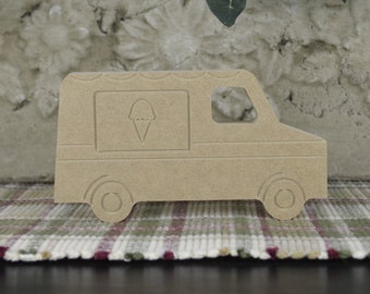 May include: A wooden cutout of an ice cream truck. The truck is brown and has a window with an ice cream cone inside. The truck has wheels and a rounded roof.