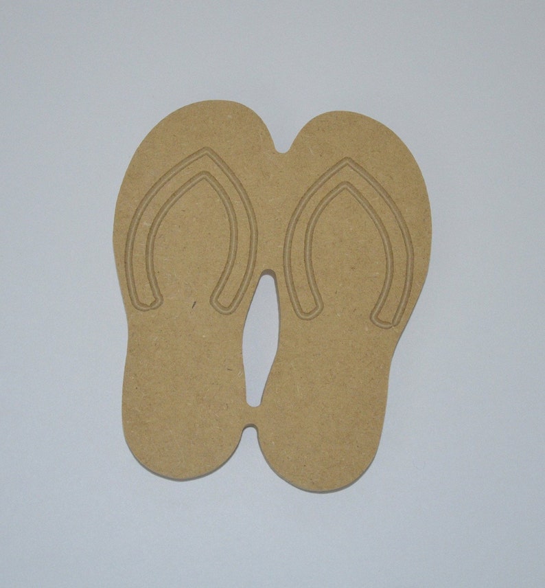 May include: A pair of brown wooden flip-flop cutouts. The flip-flops are connected at the toe and heel.