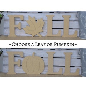 May include: Unpainted wooden letters spelling "FALL" with a choice of either a maple leaf or a pumpkin cutout.  The letters are on a white wood background.  ~Choose a leaf or pumpkin~