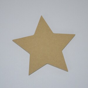 May include: A large, five-pointed star shape cut from light brown wood. The star is flat and has a smooth surface.