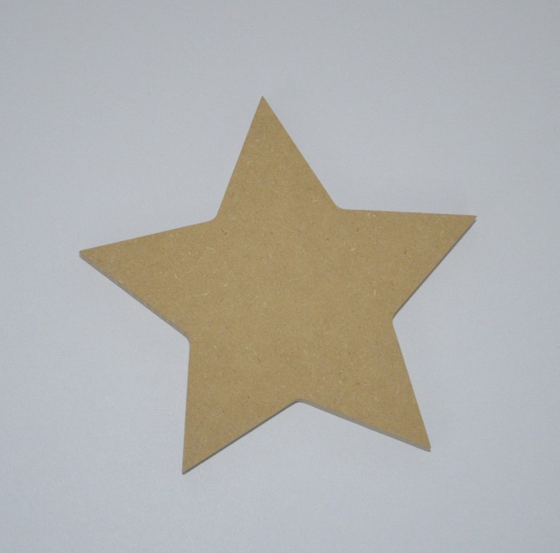 May include: A large, five-pointed star shape cut from light brown wood. The star is flat and has a smooth surface.