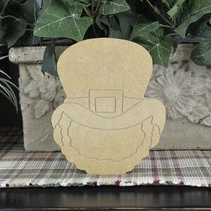 May include: Unfinished wooden cutout of a leprechaun's head with a hat and beard. The cutout is ready to be painted.