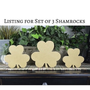 May include: Set of three wooden shamrock shapes in various sizes. The shamrocks are unpainted and ready to be decorated.