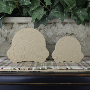 May include: Two unfinished wooden bunny butt shapes. The larger bunny butt is 6 inches tall and the smaller bunny butt is 4 inches tall.