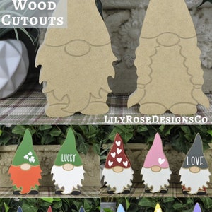 May include: Wooden gnome cutouts in various designs. The top row features two unfinished gnomes. The bottom rows display painted gnomes with different colored hats, beards, and text, including "Lucky," "Love," and "Hello Spring."