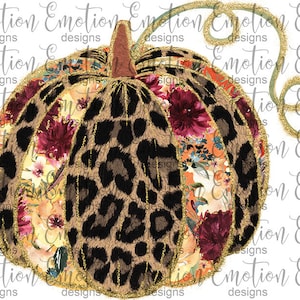 May include: A gold glitter pumpkin with a leopard print and floral pattern. The pumpkin has a stem and a vine.
