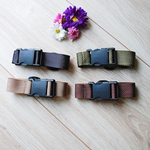 May include: Four adjustable straps with black plastic buckles. The straps are in different colors: brown, black, green, and burgundy.