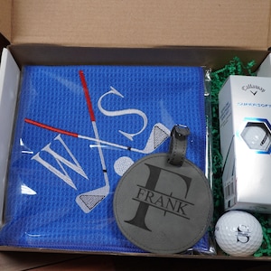 Personalized Golf Gift Box. Include a golf towel, a set of three golf balls with monograms, and a golf bag tag with tee holder