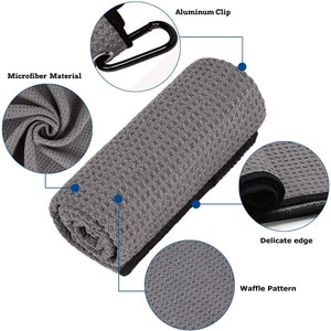 Puede incluir: Una toalla de microfibra gris con un patr&oacute;n de gofre y un borde negro. La toalla tiene un clip de aluminio y un borde delicado.