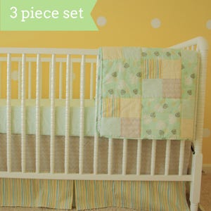 May include: A white crib with a green and yellow striped crib skirt and a green and yellow patchwork quilt. The text "3 piece set" is visible in the image.