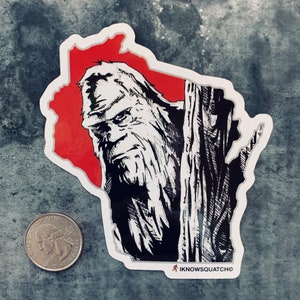 May include: A black and white illustration of Bigfoot standing behind a tree, with a red background shaped like the state of Wisconsin. The illustration is on a white sticker with the text "IKNOWSQUATCH" in the bottom right corner.
