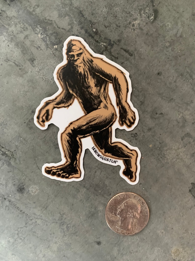 May include: A brown and black sticker of a Bigfoot walking with the text "Knowsquatch" on the bottom.
