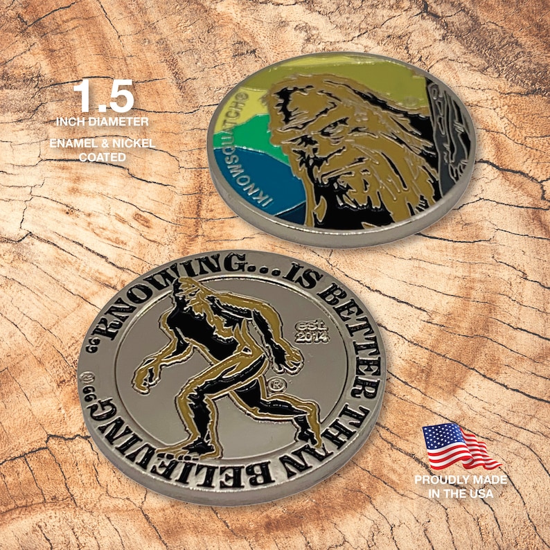 May include: Two 1.5 inch diameter enamel and nickel coated metal coins. One coin features a colorful graphic of a sasquatch with the text "IKNOWSOLATCHO". The other coin features a black and white graphic of a sasquatch with the text "SEEING... IS BETTER THAN BELIEVING" and "EST. 2014".