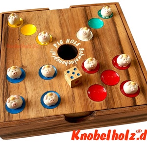 Op de afbeelding: Houten Pig Hole-spel met een dobbelsteen en varkensbeeldjes. Het spelbord heeft een donkere houtnerf afwerking met kleurrijke cirkels en de tekst "PIG HOLE Schweinchenspiel". Het spel bevat een houten dobbelsteen en kleine varkensbeeldjes.