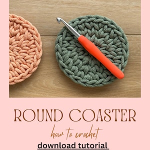 May include: Two crocheted round coasters, one in a light peach colour and one in a dark green colour, with a red crochet hook lying on top of the green coaster. The text "ROUND COASTER" is written in brown letters on a pink background, with the text "how to crochet" written in cursive below it, and the text "download tutorial" written in black letters below that.