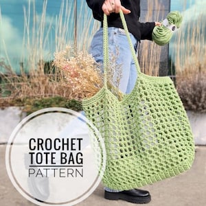 May include: A crochet tote bag pattern featuring a green crochet tote bag being held by a person. The bag is made with a simple stitch and has a large open weave. The bag is filled with dried flowers.