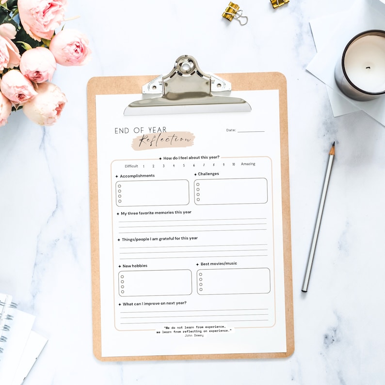May include: A printable end-of-year reflection worksheet with sections for accomplishments, challenges, favorite memories, things you are grateful for, new hobbies, best movies/music, and what you can improve on next year. The worksheet includes the quote "We do not learn from experience, we learn from reflecting on experience." - John Dewey.