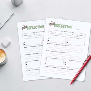 May include: Two white "Reflection" worksheets with a red pen, a laptop, and a coffee cup with latte art. The worksheets have prompts for self-reflection, including areas for praises, hardships, and answered prayers.