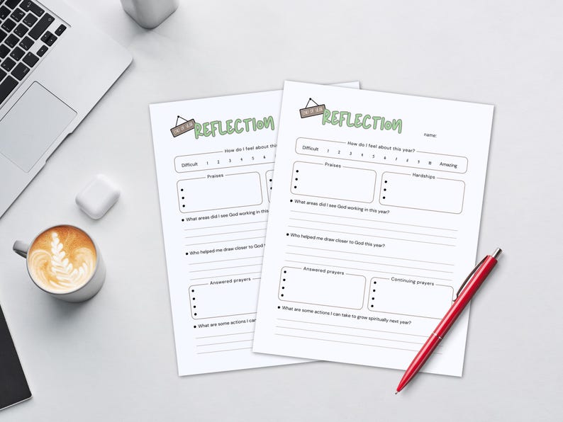May include: Two white "Reflection" worksheets with a red pen, a laptop, and a coffee cup with latte art. The worksheets have prompts for self-reflection, including areas for praises, hardships, and answered prayers.