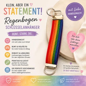Può includere: Un portachiavi in tessuto a righe arcobaleno con una chiusura in metallo argentato e un anello circolare. Il testo sull'immagine include 'KLEIN, ABER EIN STATEMENT!', 'Regenbogen SCHLÜSSELANHÄNGER', 'BUNT. STARK. DU.', 'mit Liebe HANDGEMACHT' e 'DU BIST WERTVOLL!'