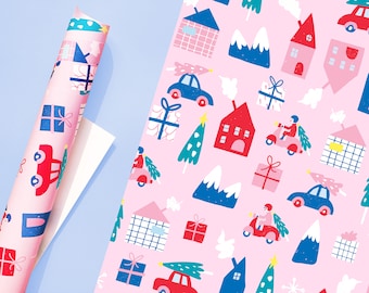 May include: Pink wrapping paper with a repeating pattern of houses, cars, trees, mountains, and gifts. The pattern is in shades of red, blue, green, and white.