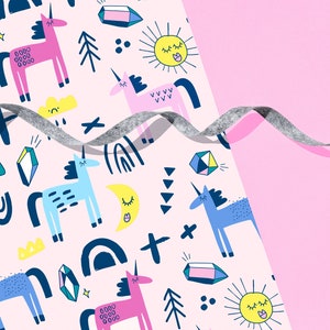 May include: A pink background with a repeating pattern of unicorns, rainbows, stars, and crystals. The pattern is cut off by a gray ribbon that is curled and extends to the right side of the image.