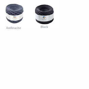 May include: Two spools of black and dark gray yarn. The yarn is made of recycled plastic and is packaged in a clear plastic bag. The spools are labeled "Rainbow Recycled Yarn".