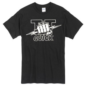 May include: Black t-shirt with a white graphic of a fist with a lightning bolt and the text "TT QUICK".